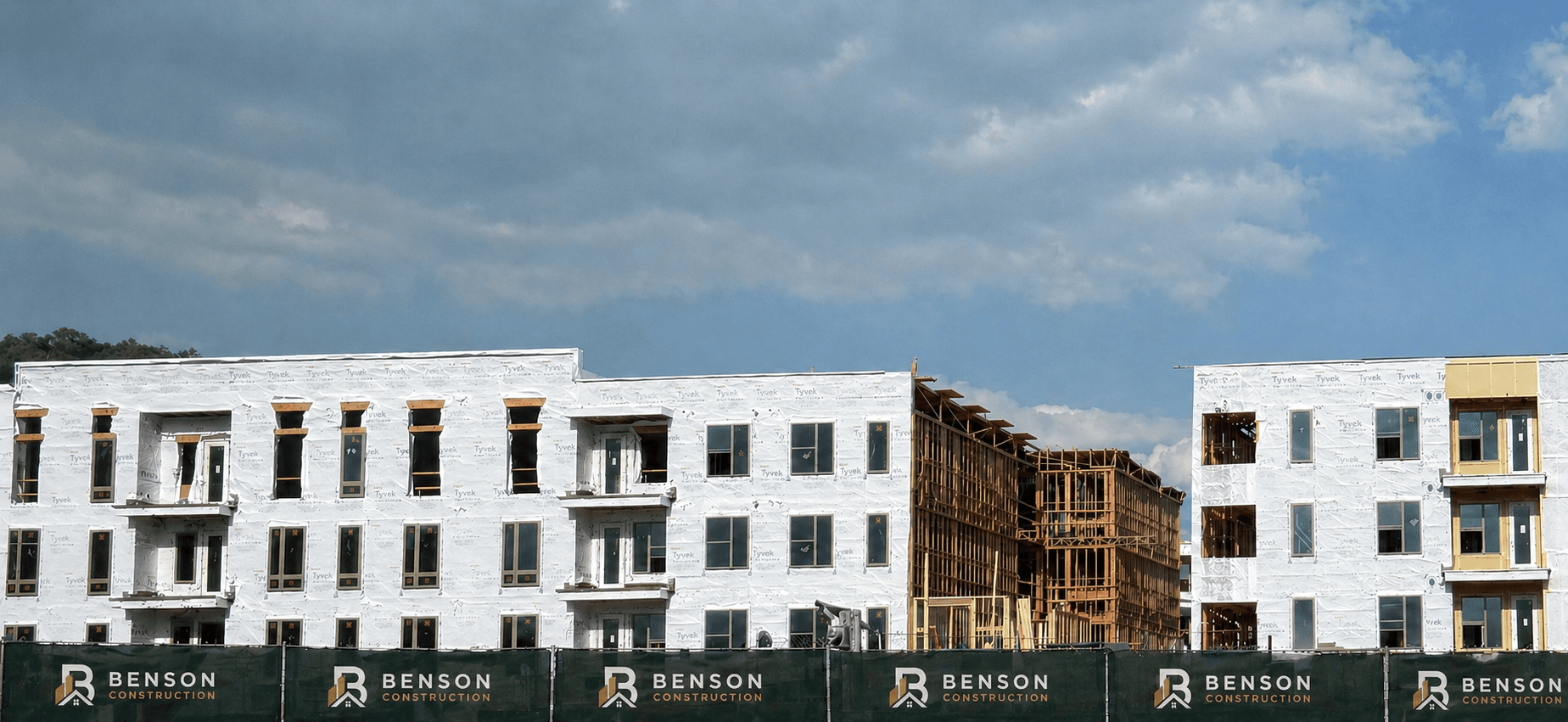 Benson Construction commercial building project under construction with branded site fencing.
